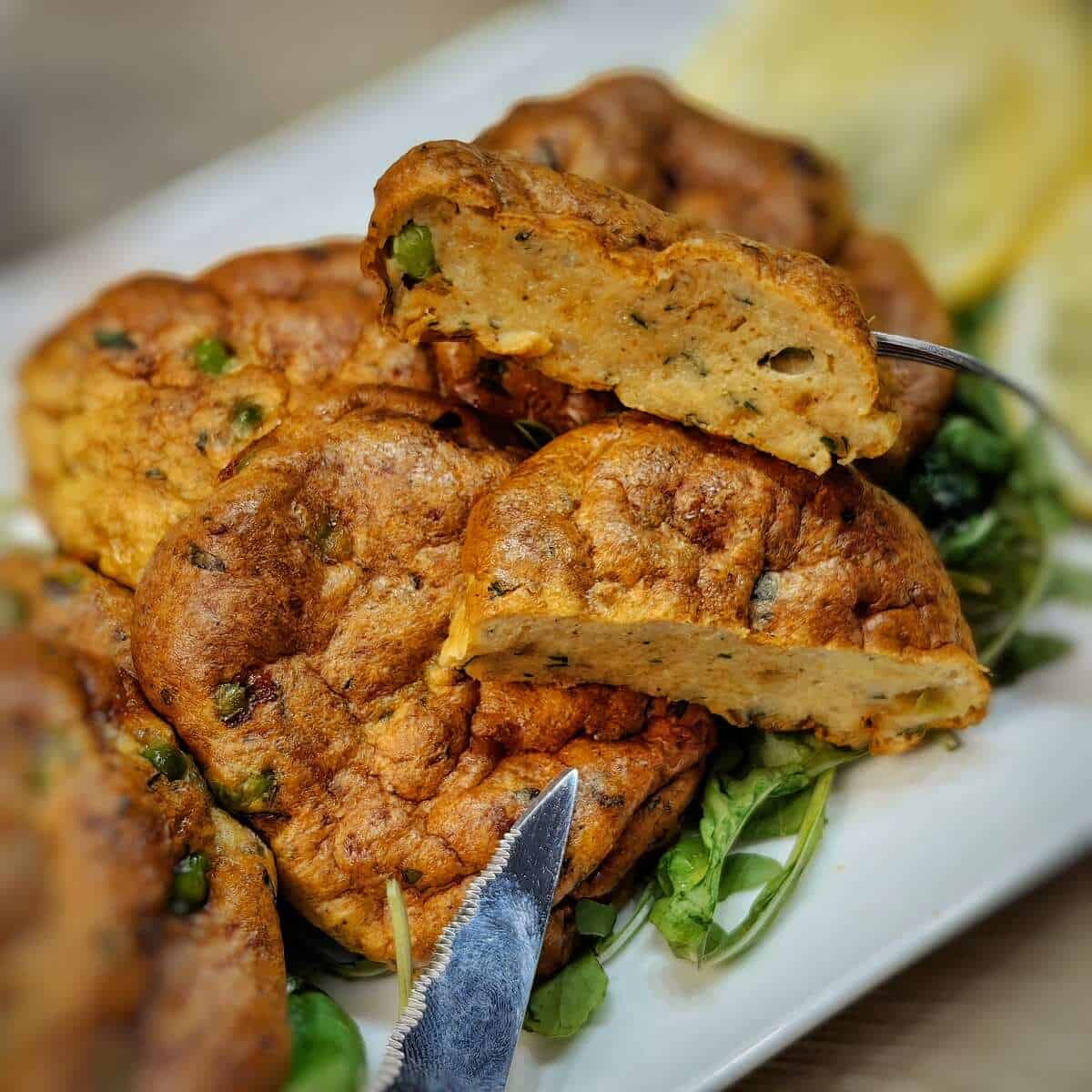 air fryer fish cakes on a bed of greens