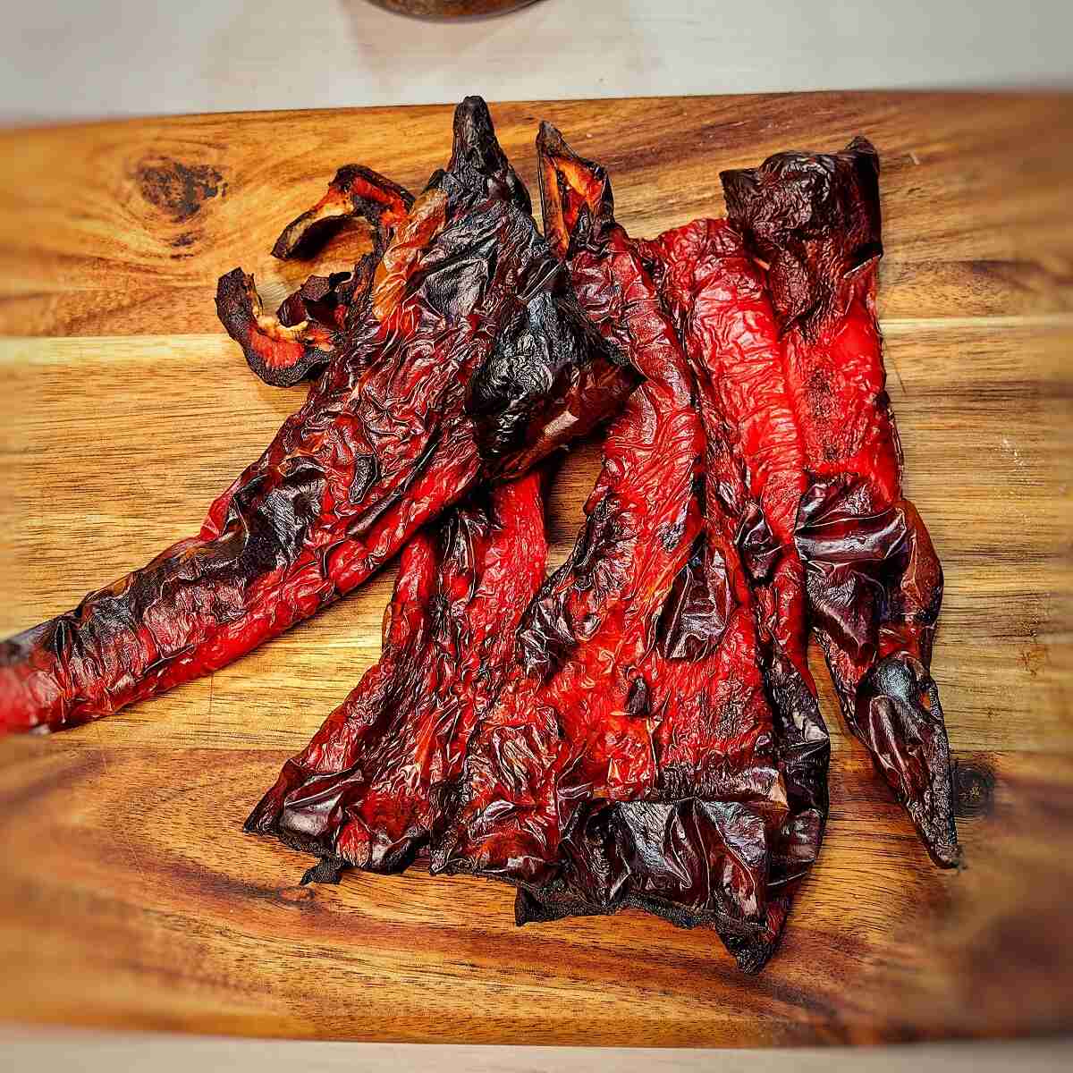charred Ramiro peppers on a chopping board