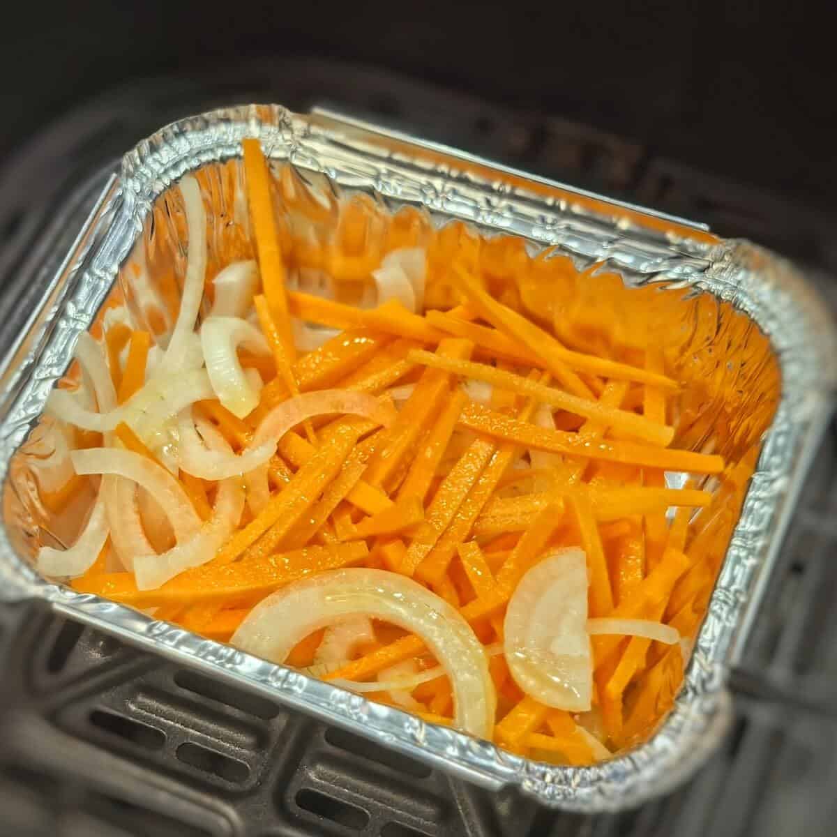 thinly sliced onions and carrots with olive oil