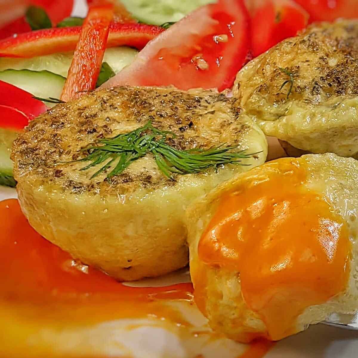 close up of air fryer egg bites with vegetable slices on the side