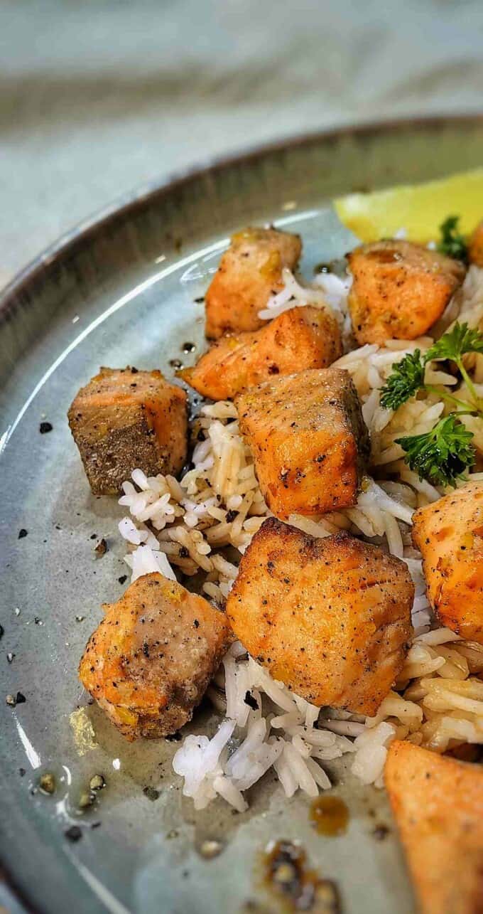 close up of air fryer salmon bites with rice