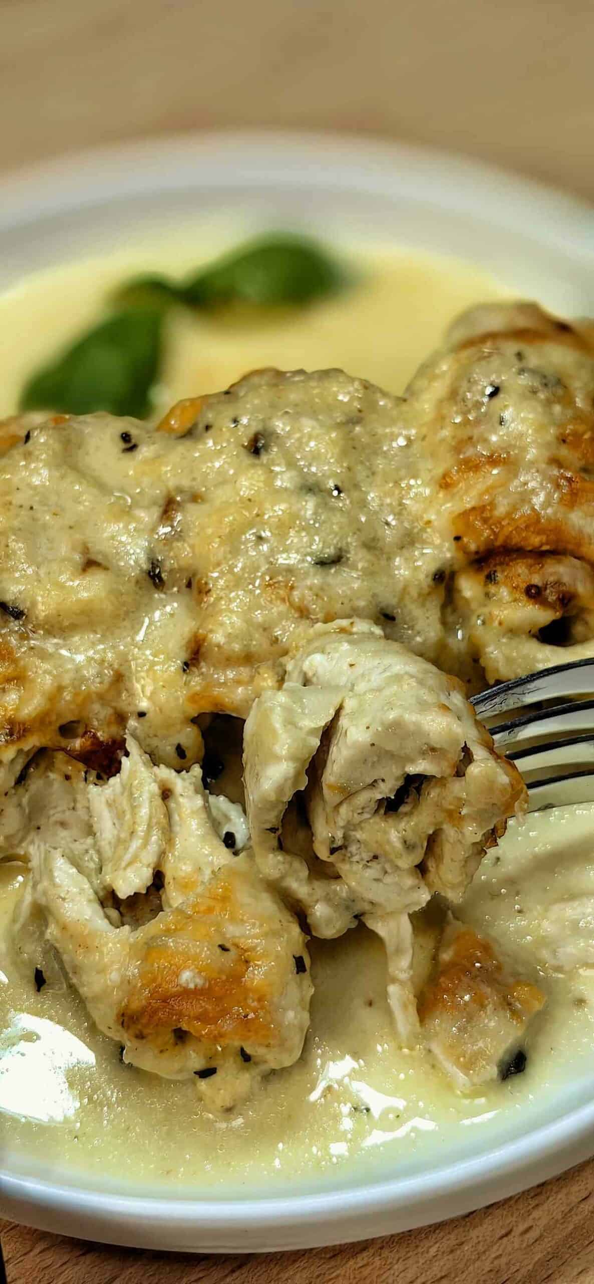 air fryer stuffed chicken breast roll-ups with sauce on a serving plate