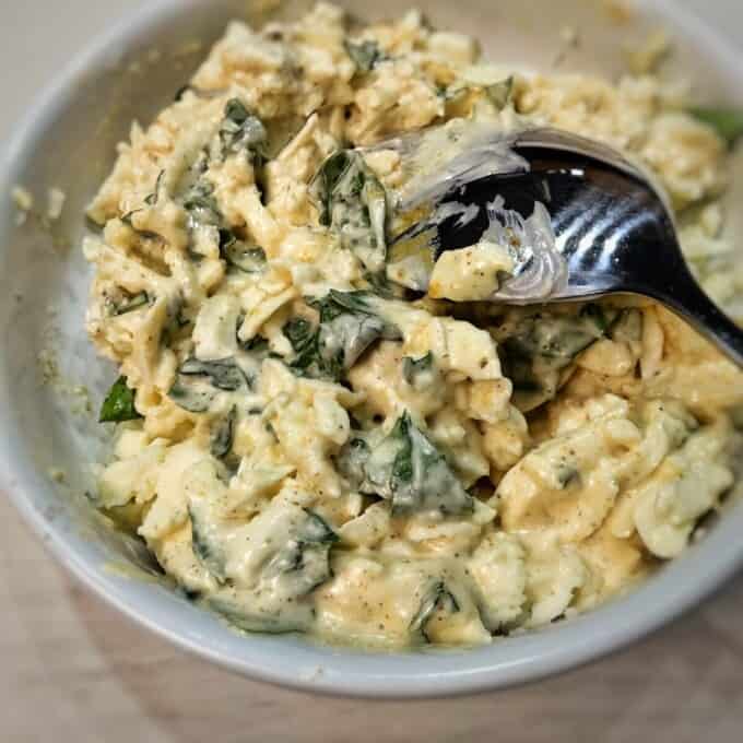 mixture of cheese and herbs inside white bowl
