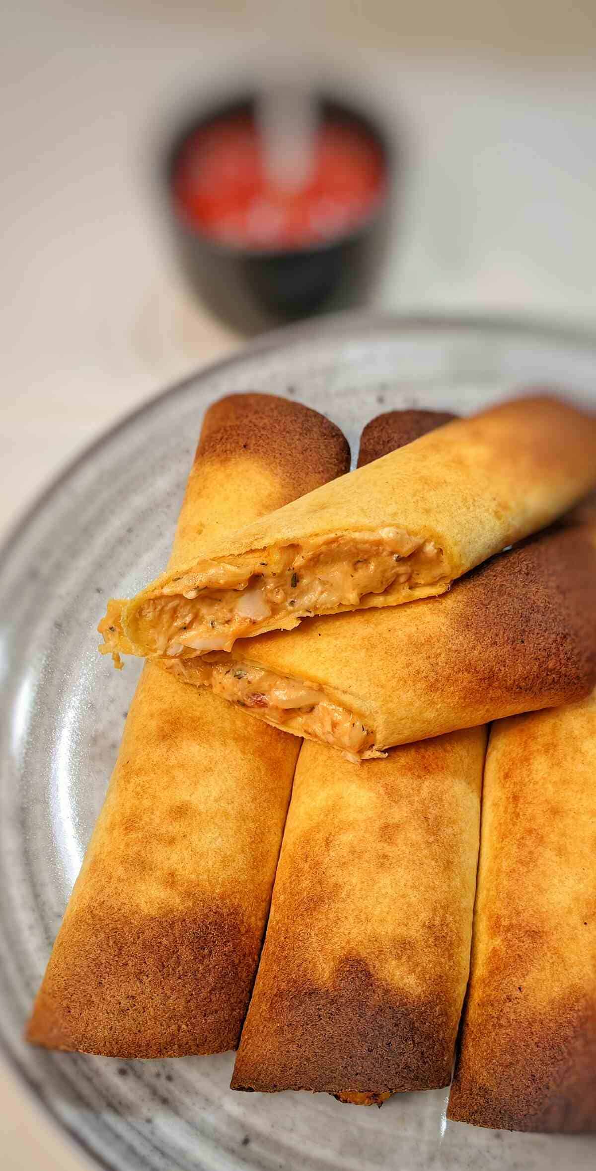 air fryer taquitos on a glass serving plate