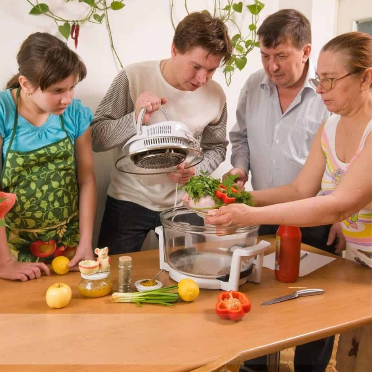 family in the kitchen looks at an air fryer