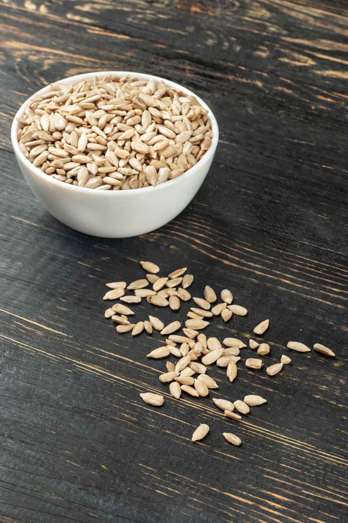 white bowl with sunflower seeds without shell on the table