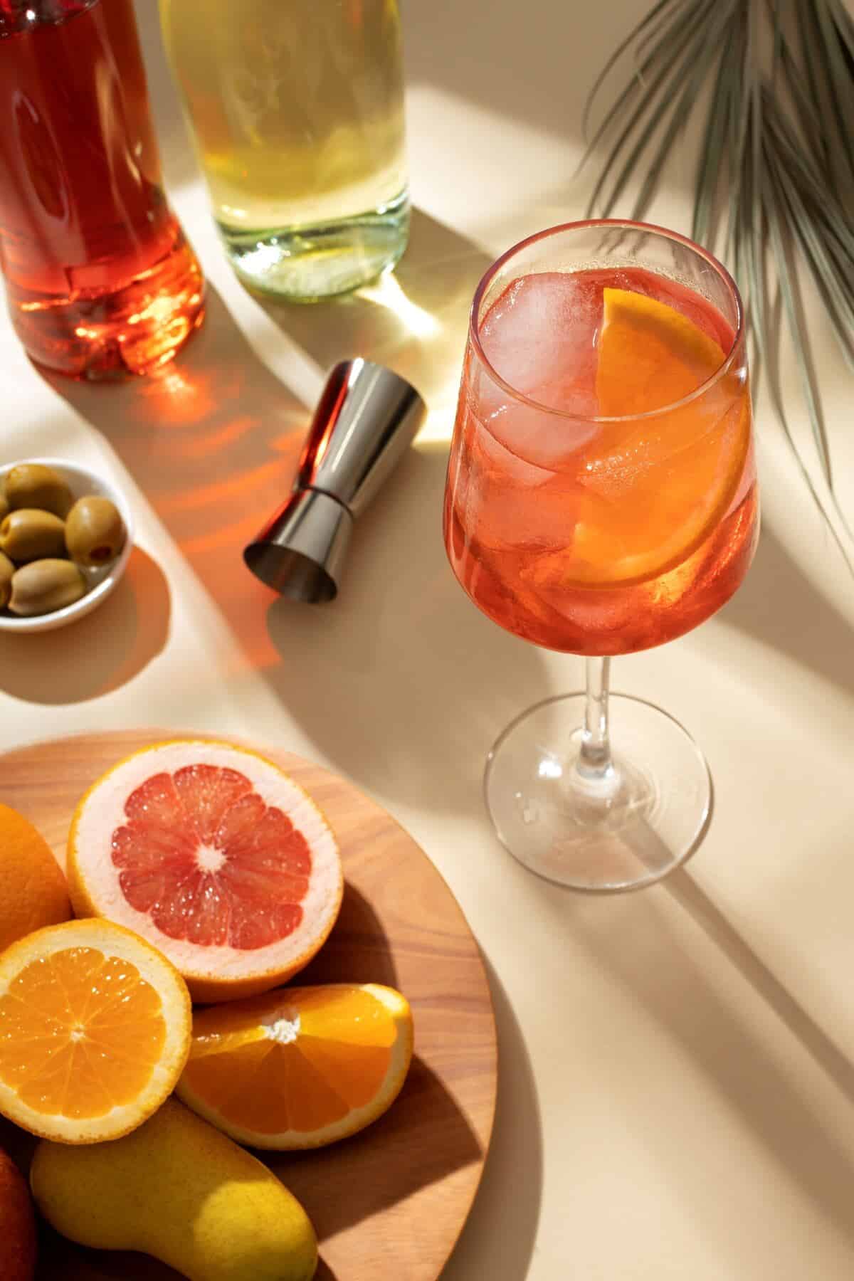 italian dry martini cocktail in a glass and a plate of fruit on the table