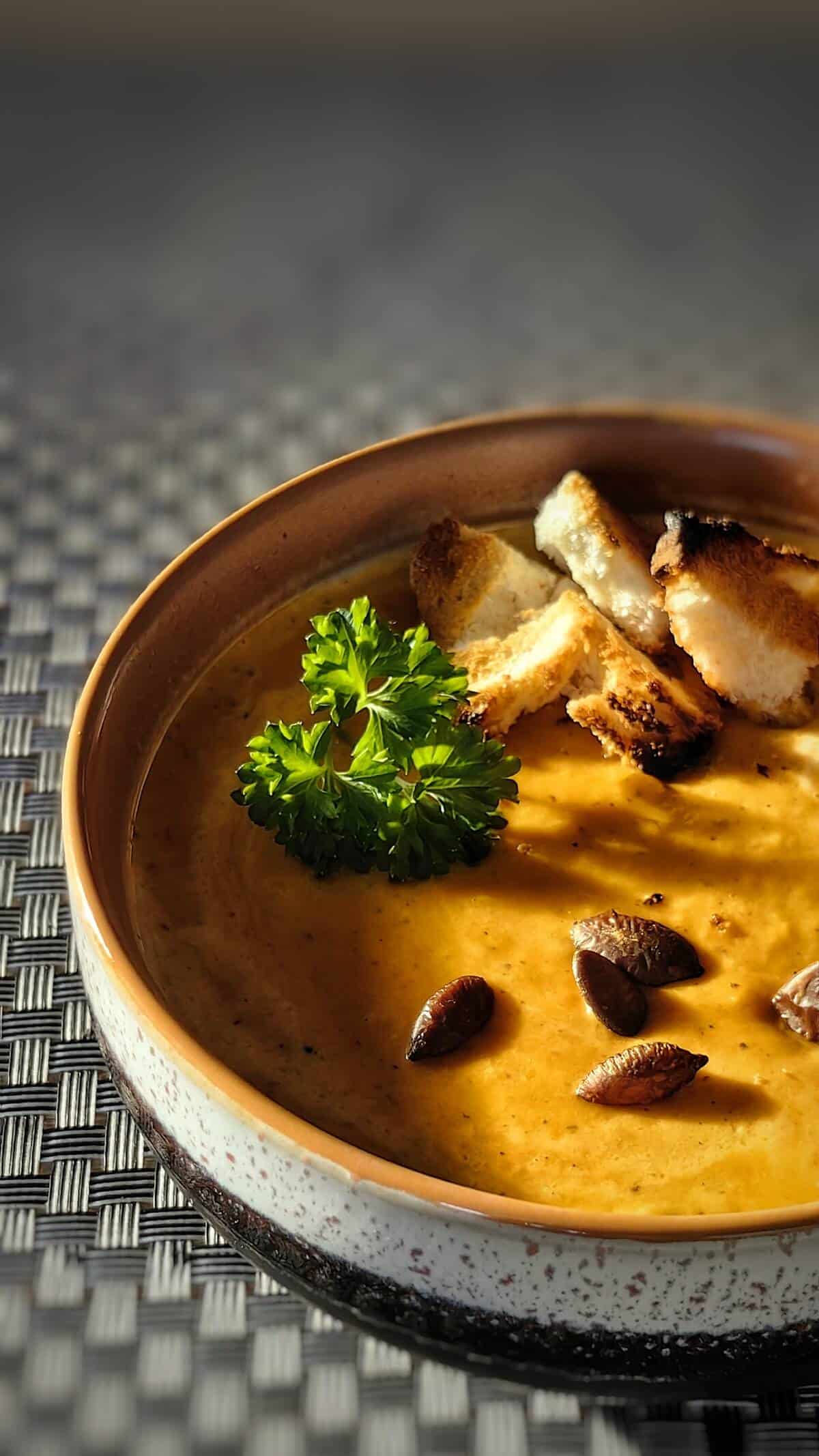 close up photo of a bowl of air fryer pumpkin cream soup