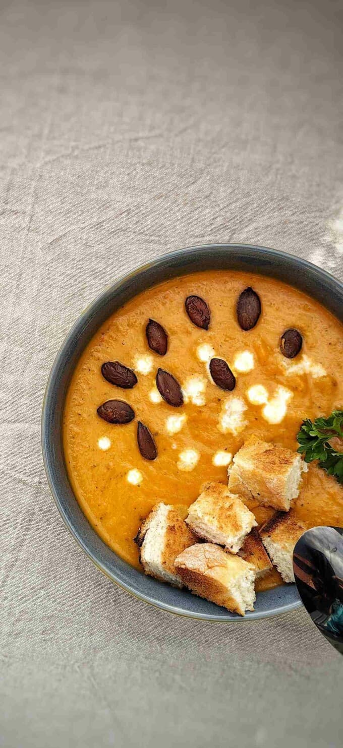 bowl of air fryer pumpkin cream soup with croutons