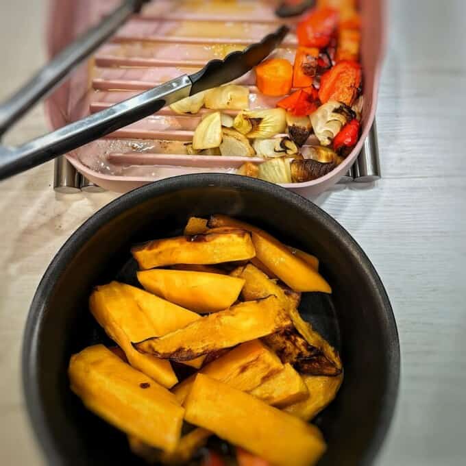 removing roasted vegetables in the silicone mold and transferring to an oven safe pot