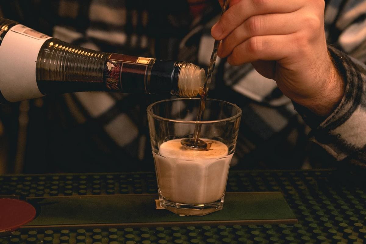 bartender preparing creamy liqueur with amaretto