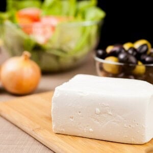 close up of feta cheese on wooden board