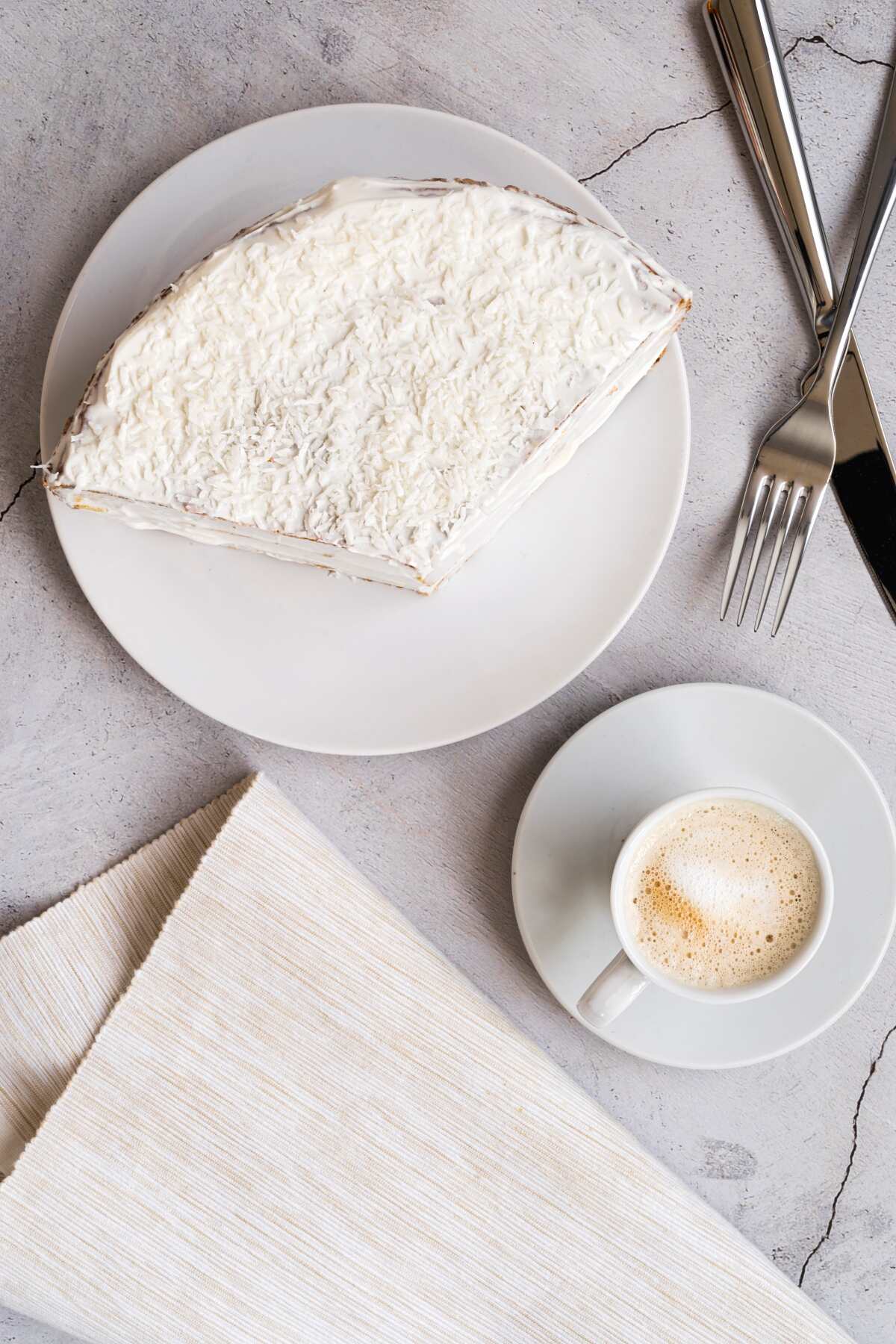top view tasty piece of cake on a plate and a cup of coffee