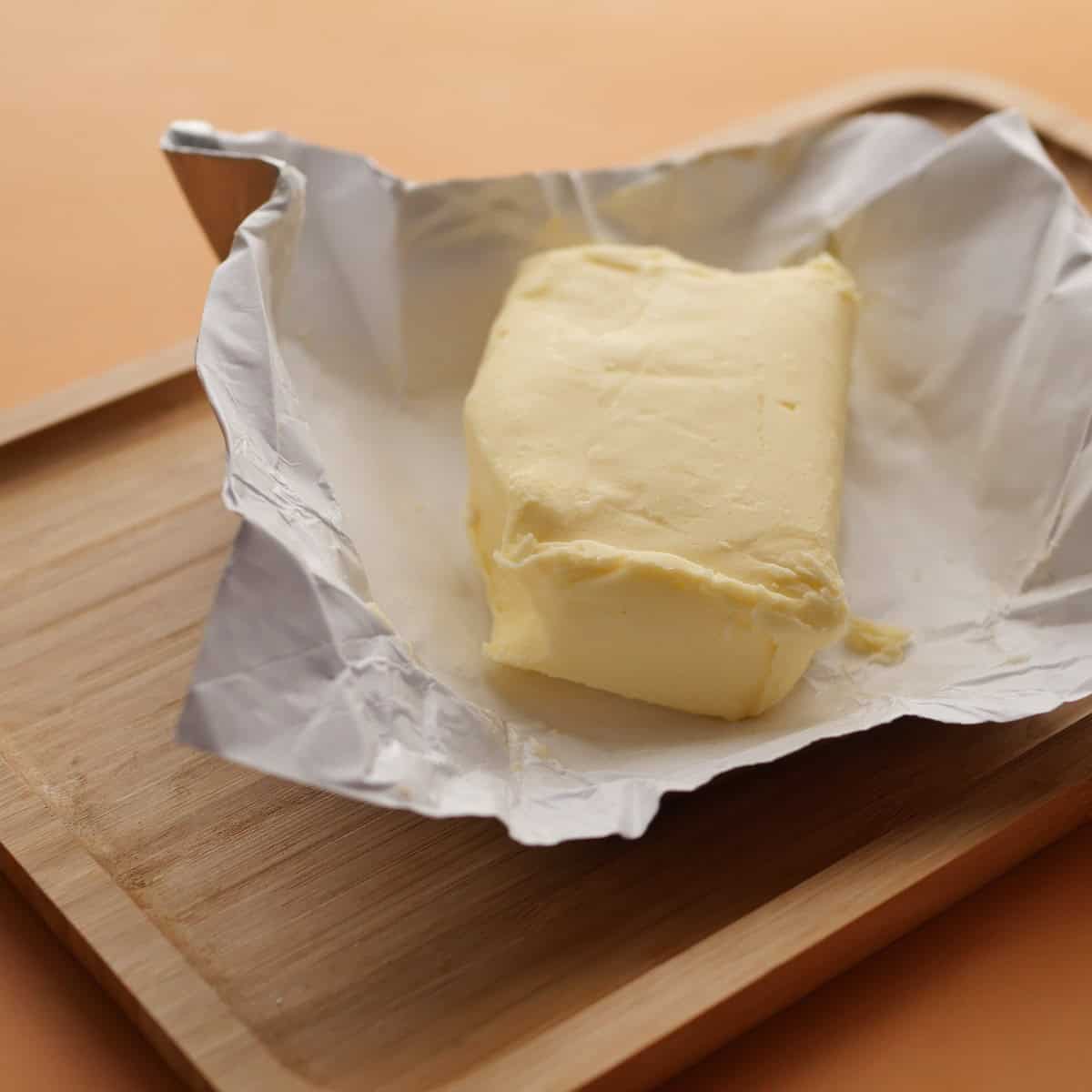 slice of a butter on a paper on table