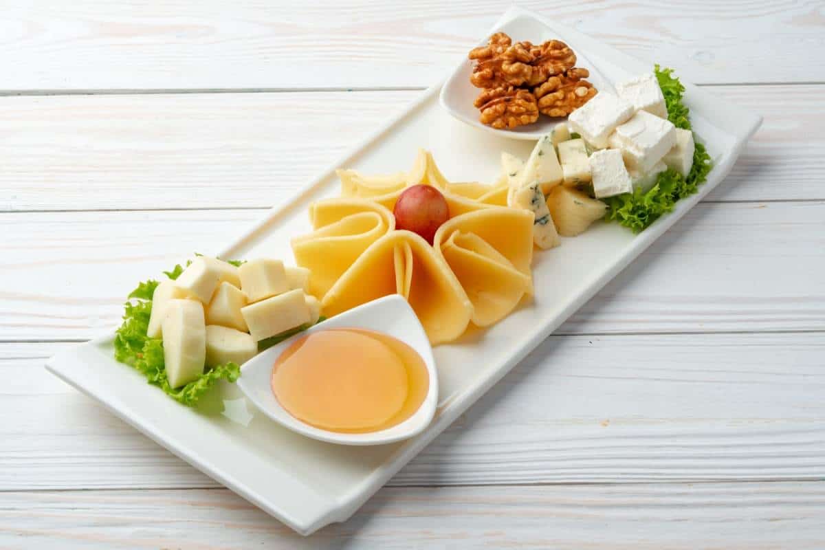 assortment of cheese on a white plate on table