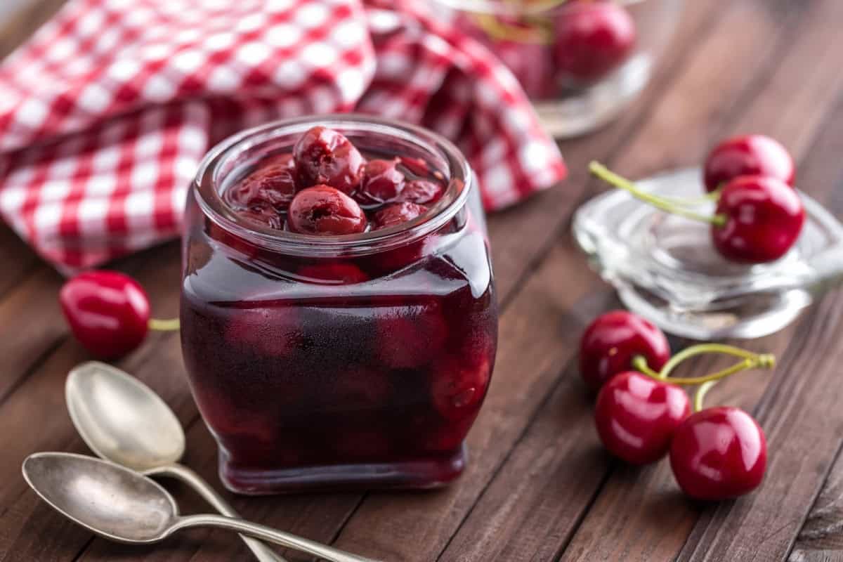 berries cherry with syrup in a glass jar