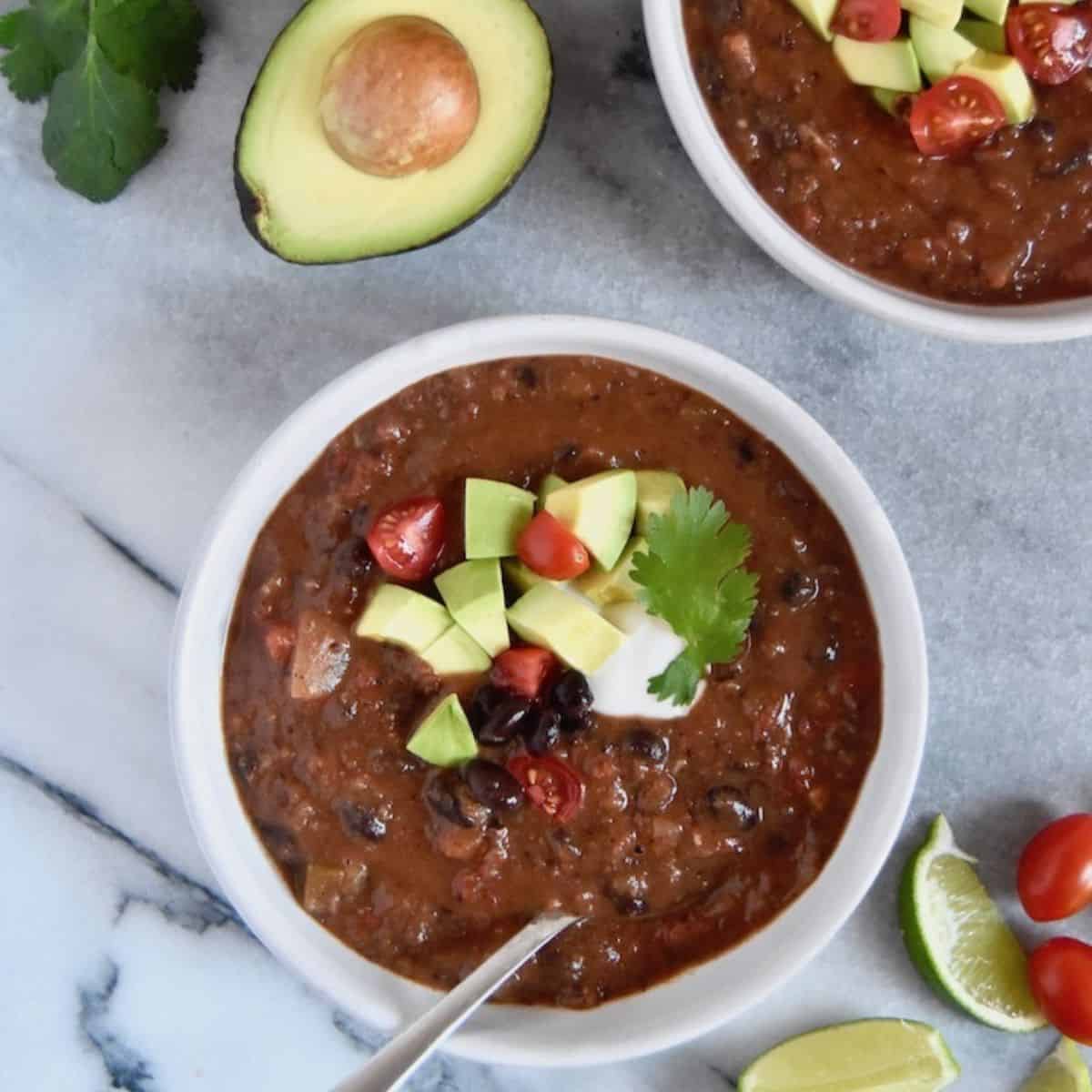 black bean and chili soup with tomatoes, Cubanelle chiles, red onions, garlic cloves, carrots, and other aromatic spices