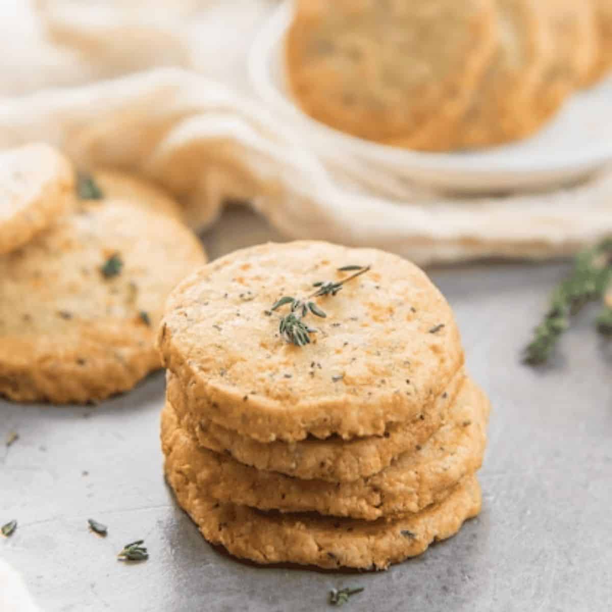 Thyme and cheddar cheese cookies, showcasing their golden-brown color and sprinkled with fresh thyme.