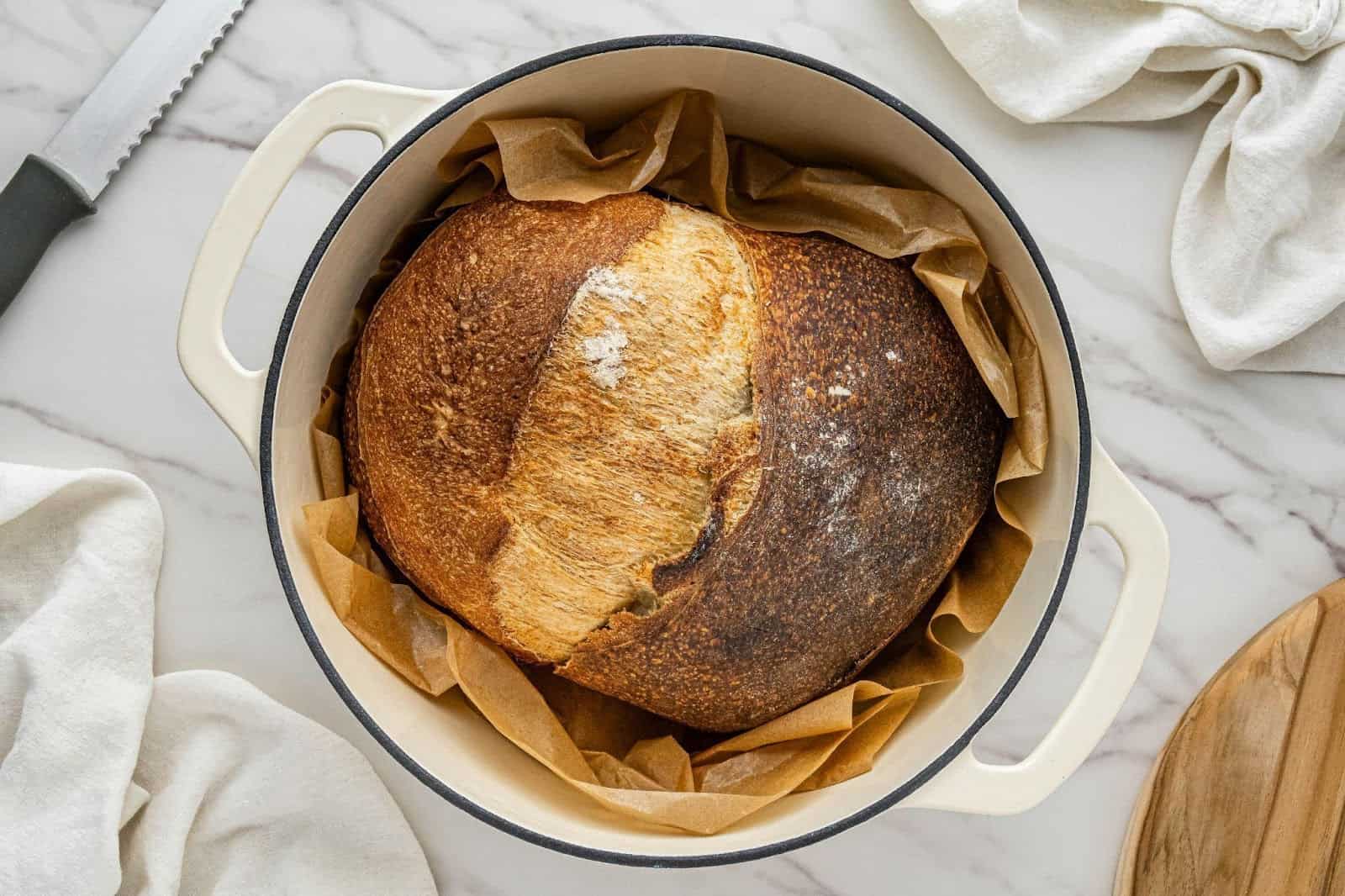 Air fryer baked brie set in a circular dish on a marble table