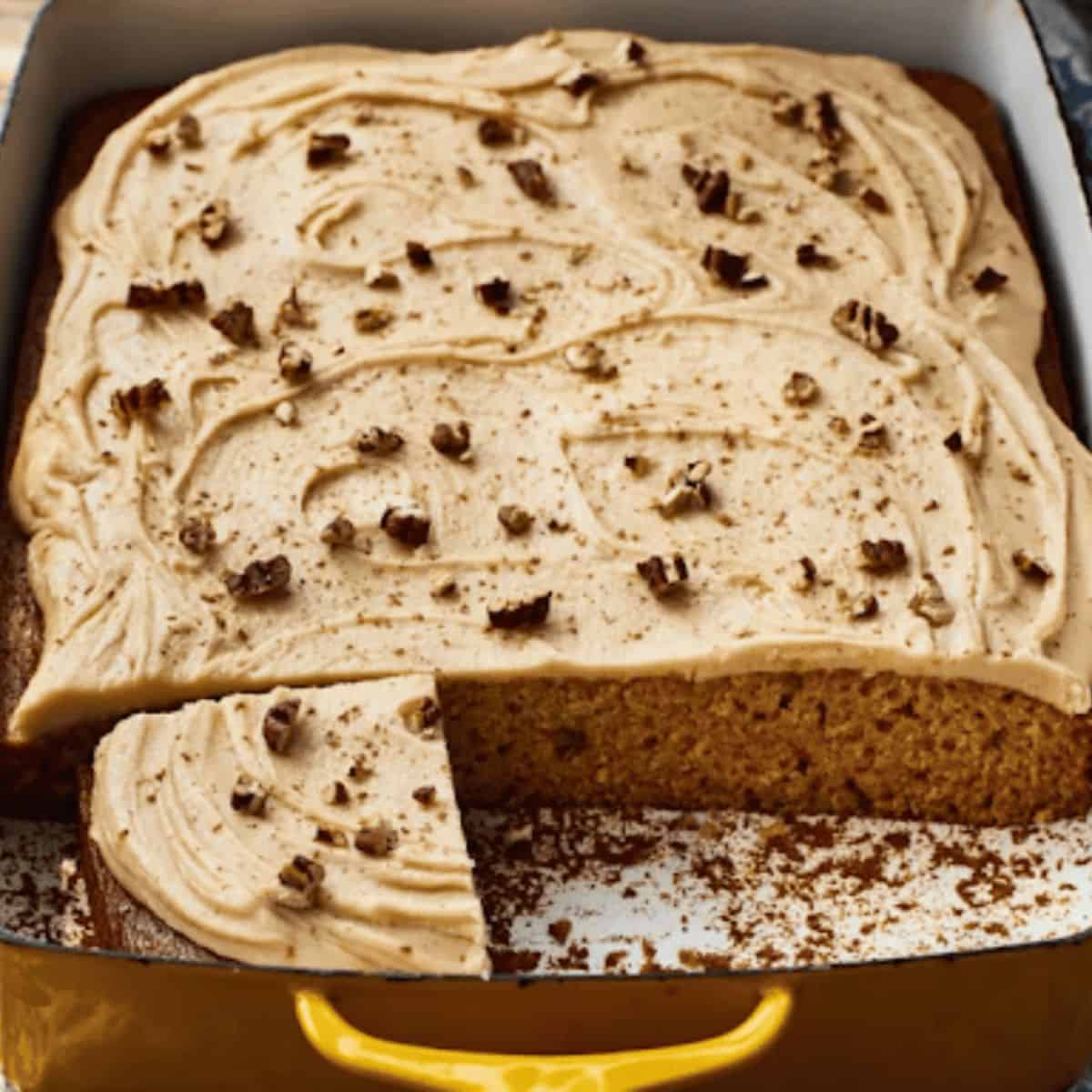 Moist applesauce snack cake topped with rich brown sugar frosting, garnished with a sprinkle of cinnamon.