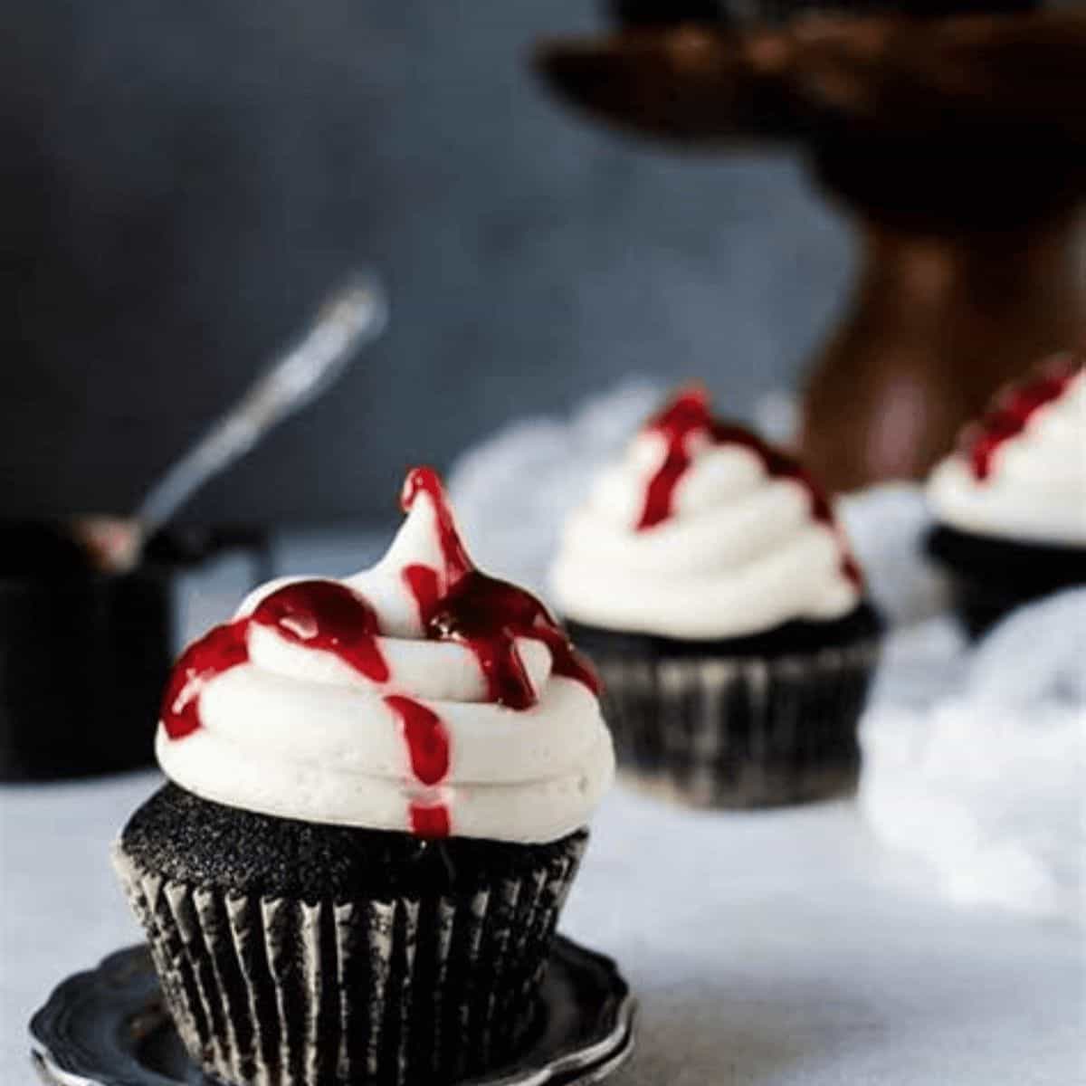 Cupcakes that look like they have blood on the top.