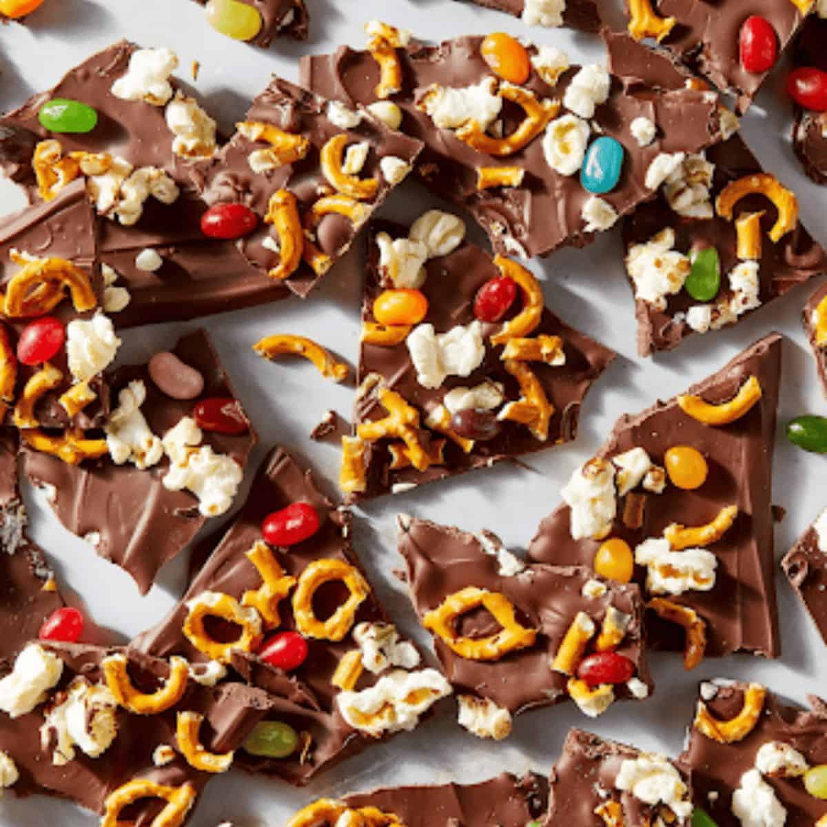 A colorful assortment of Charlie Brown Thanksgiving-inspired chocolate bark, topped with festive candy corn, mini pretzels, and jelly beans.