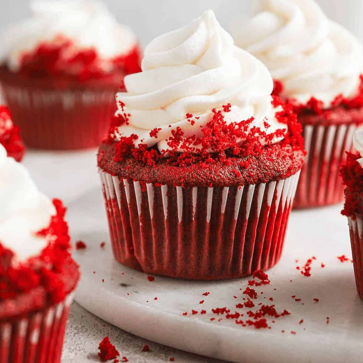 Delicious red velvet cupcakes and a sprinkle of crumbs.
