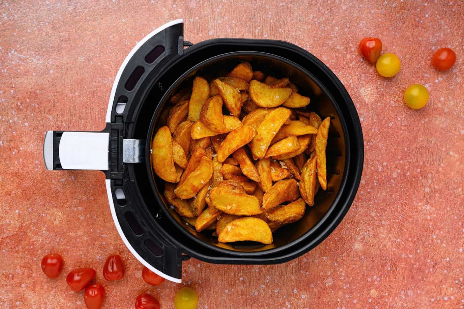 safely use your air fryer - An air fryer basket with roasted potatoes insode