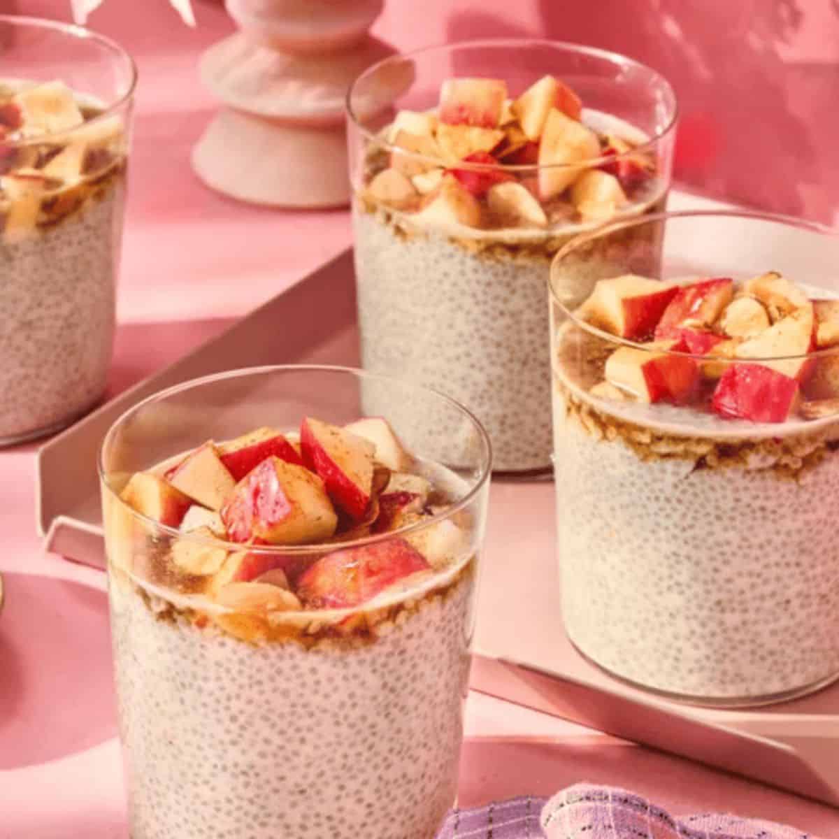 A glass of creamy Apple Cinnamon Chia Pudding topped with fresh apple slices and a sprinkle of cinnamon, offering a delicious and nutritious breakfast or snack option.