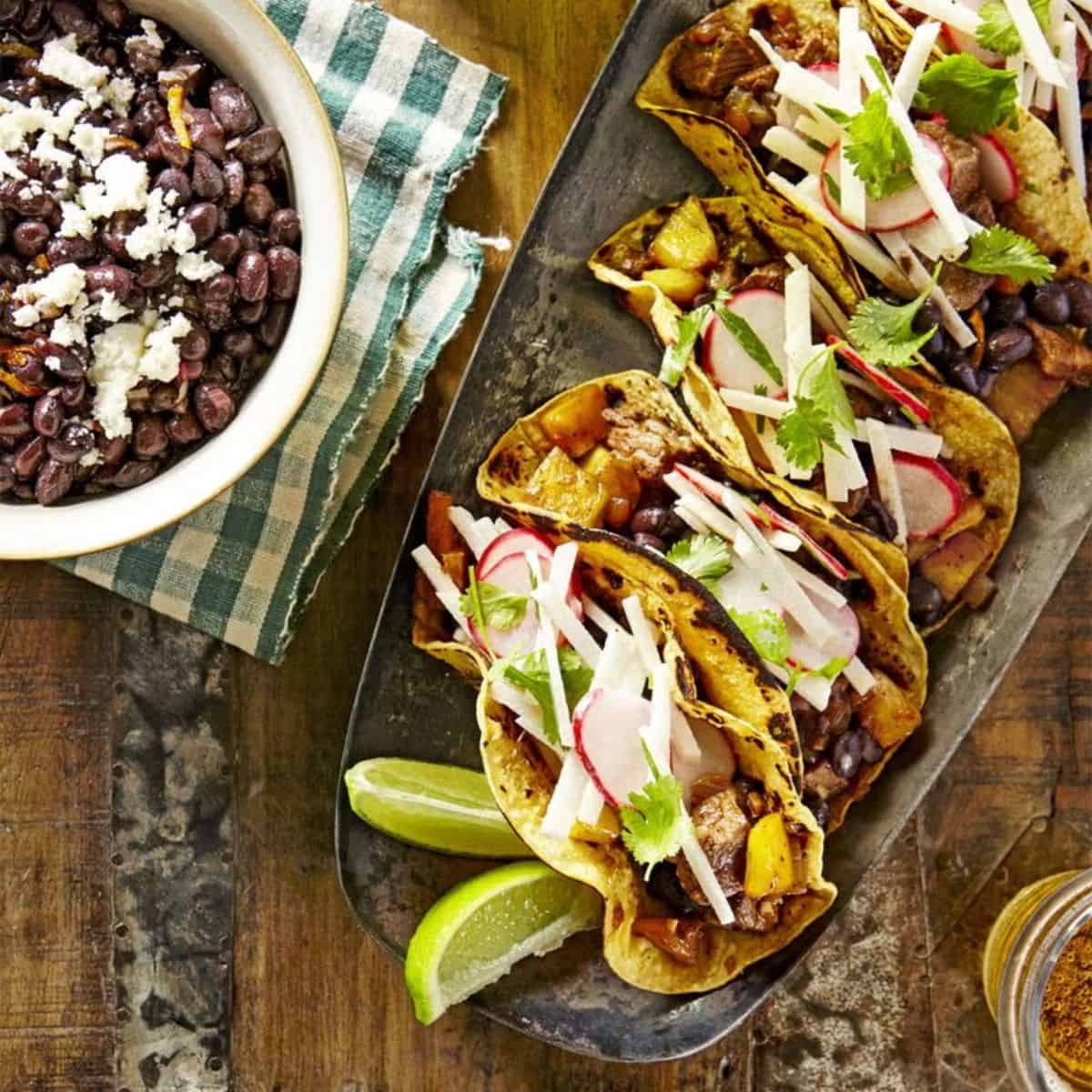 A cozy treat with beef and pineapple tacos with mojo beans 