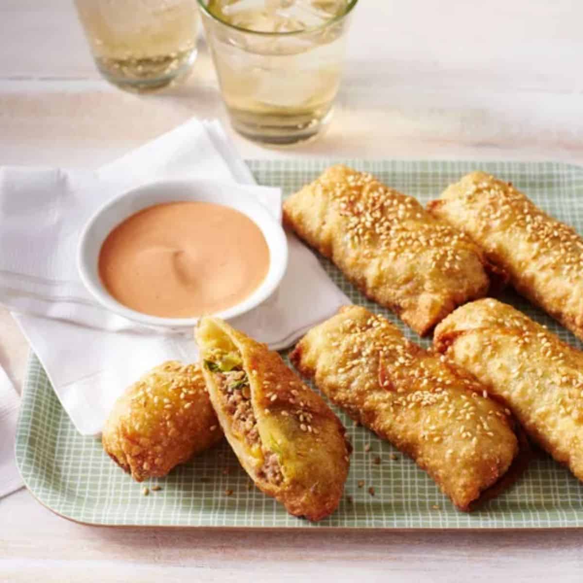 A cozy treat with cheeseburger egg rolls and special sauce. 