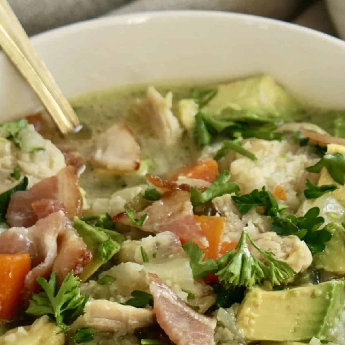 A yummy treat with chicken veggie soup with avocado. 
