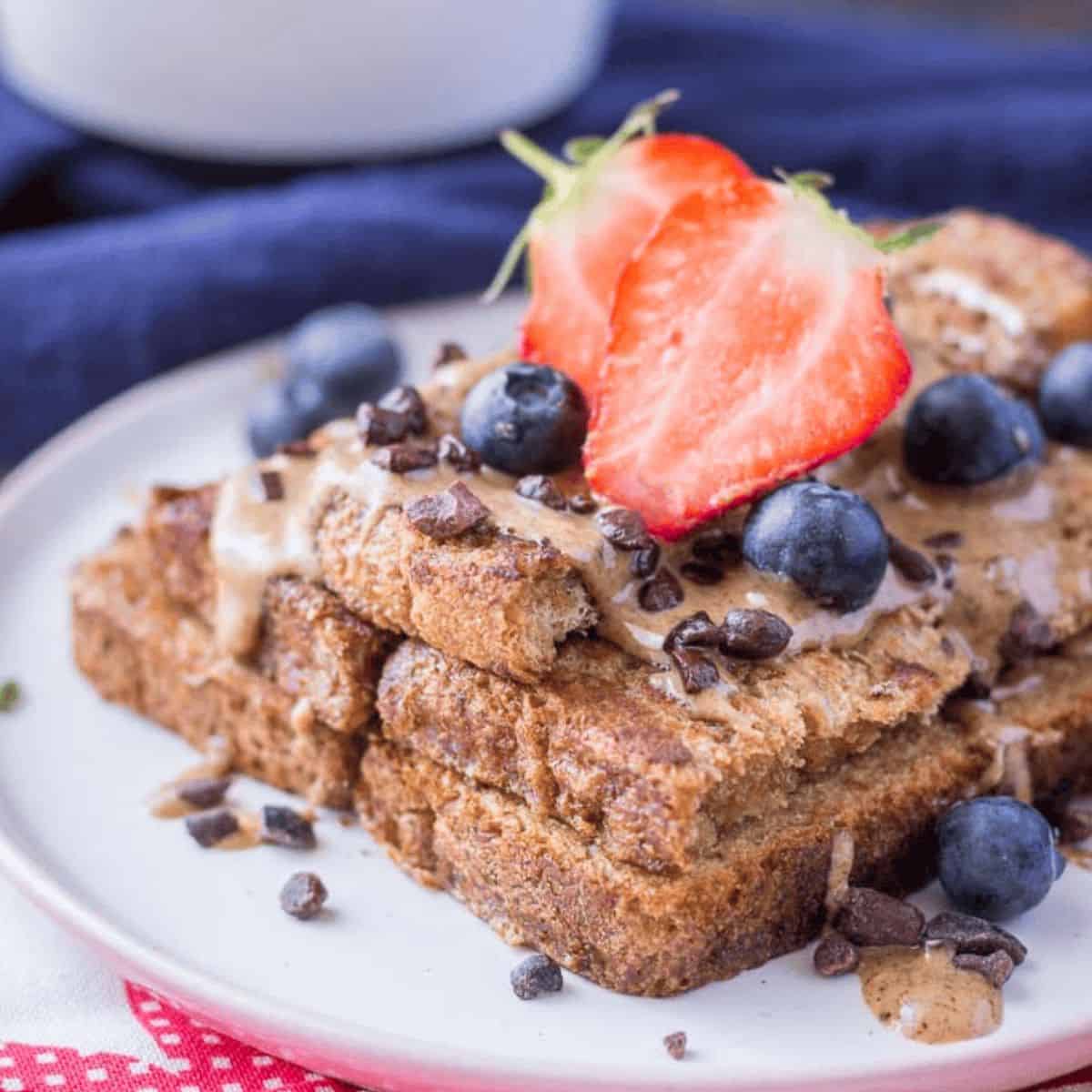 A scrumptious treat with cinnamon French toast, topped with fresh blueberries and strawberries. 