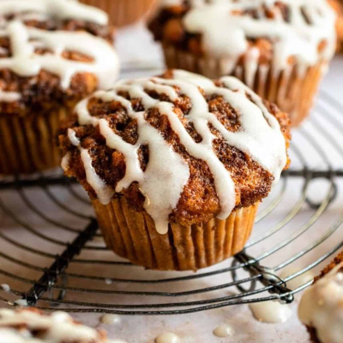 A yummy cinnamon treat featuring cinnamon roll muffins with some glazed icing on top. 