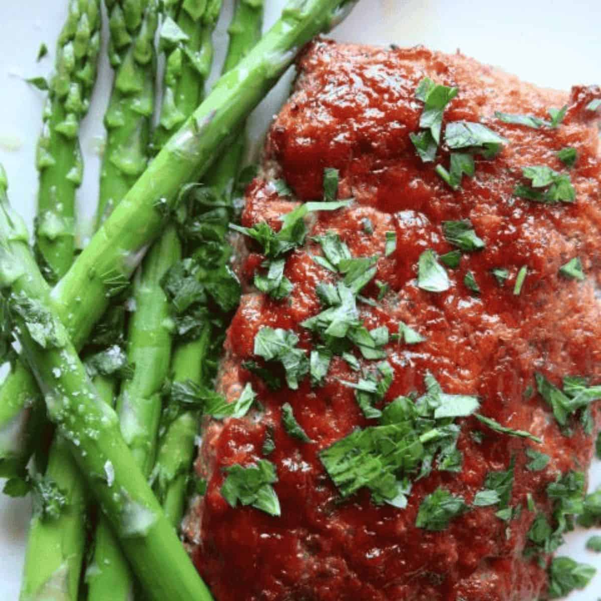 A delicious treat with glazed mini meatloaf and asparagus.