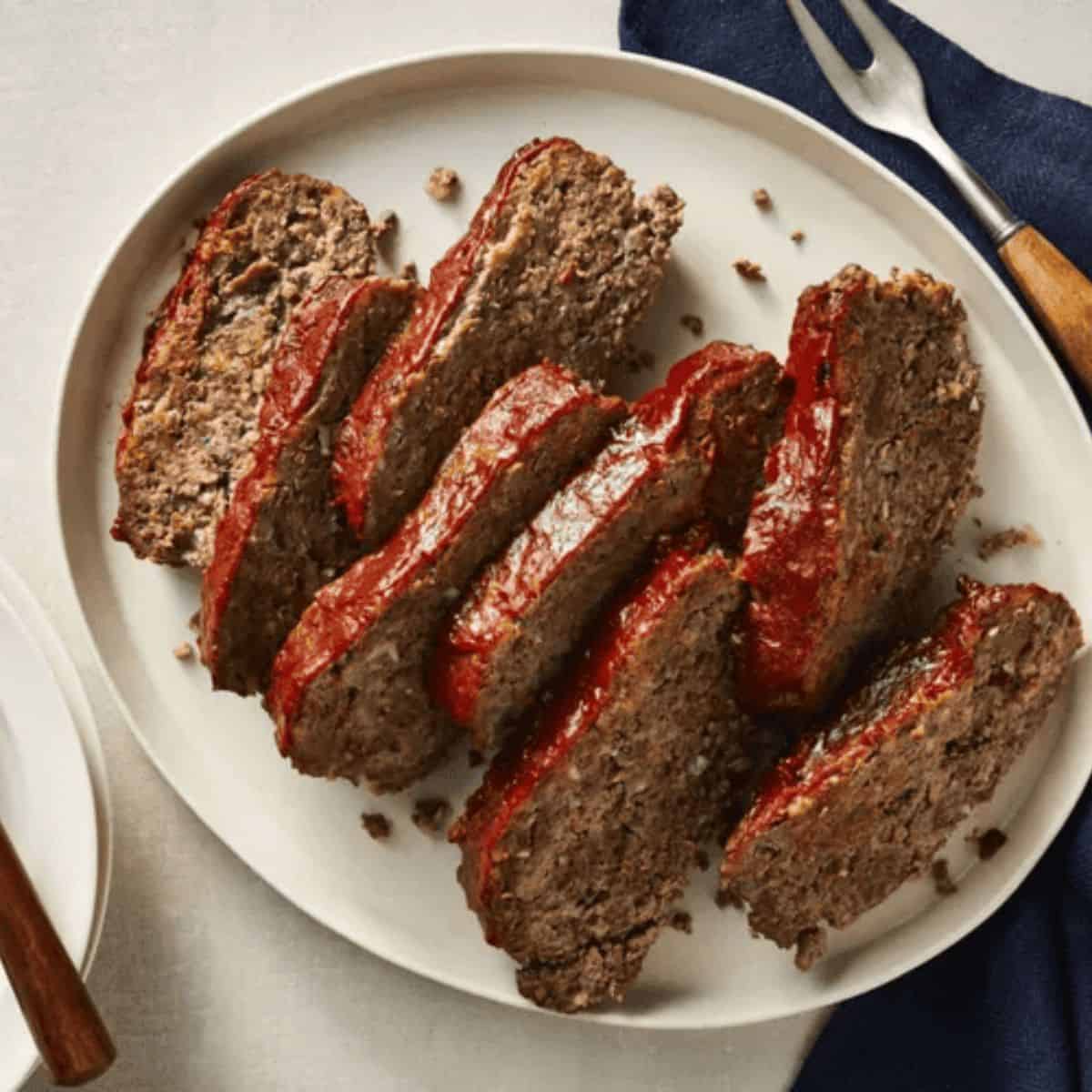 A delicious treat with instant pot meatloaf cut into slices on a circular plate.