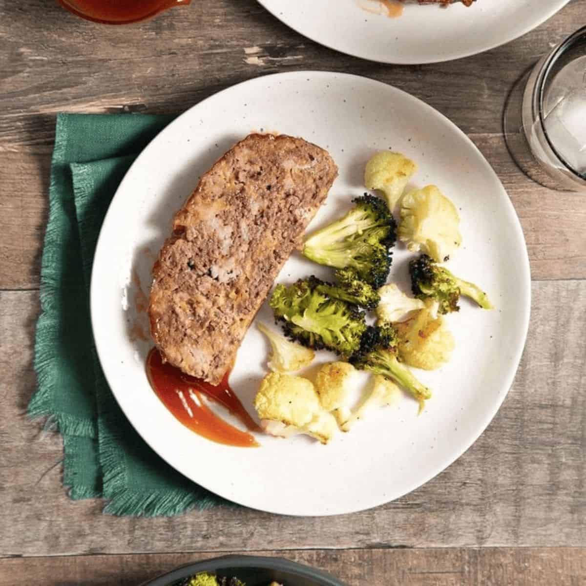Moist and savory meatloaf with broccoli and cauliflower on the side.