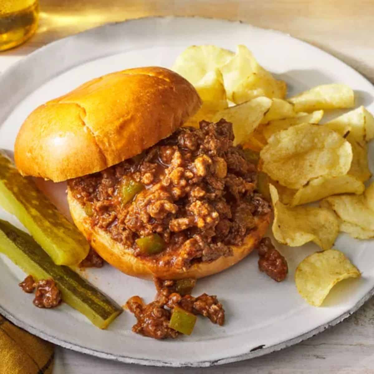 A cozy treat with sloppy joes, along with crisps on the side.