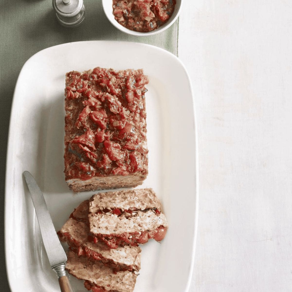 An appetizing meal featuring turkey meatloaf with spicy tomato jam in a rectangular plate.