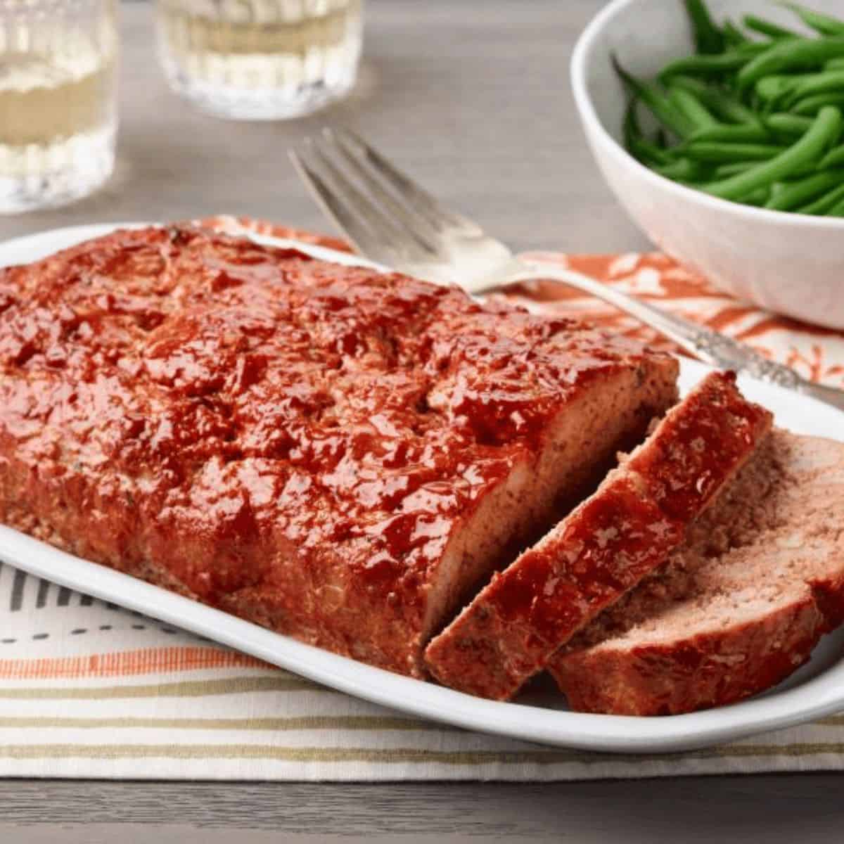 A delicious treat with turkey meatloaf in a rectangular plate.