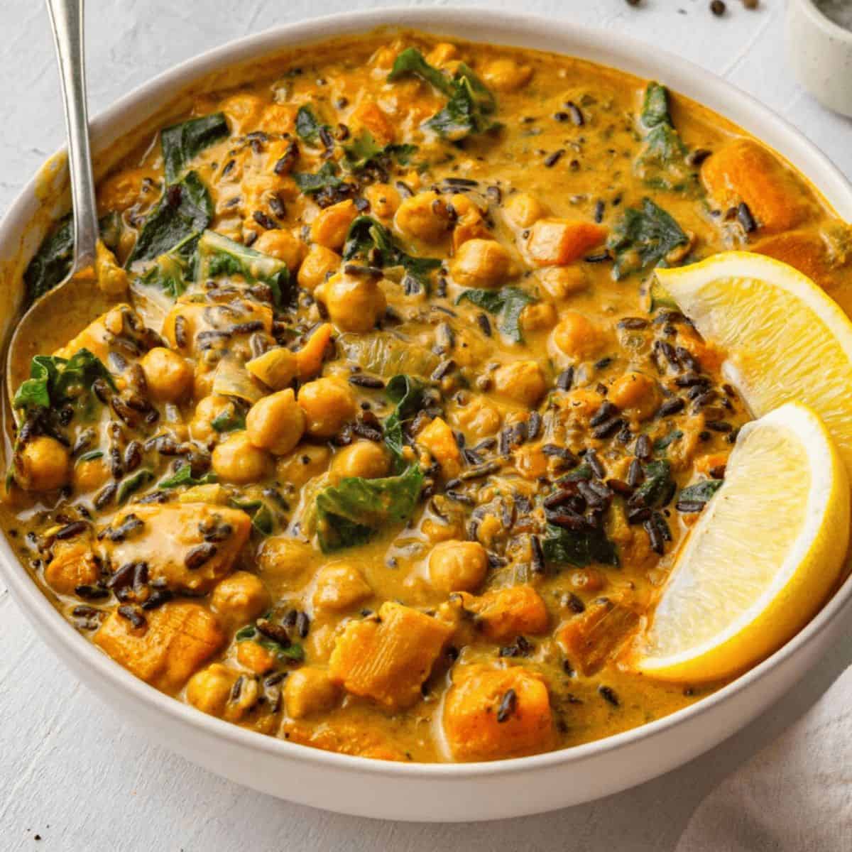 A comforting delight with vegan creamy wild rice soup and two slices of oranges on top.