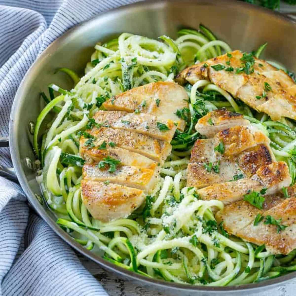 Chicken alfredo zucchini noodles in a deep steel pan. 
