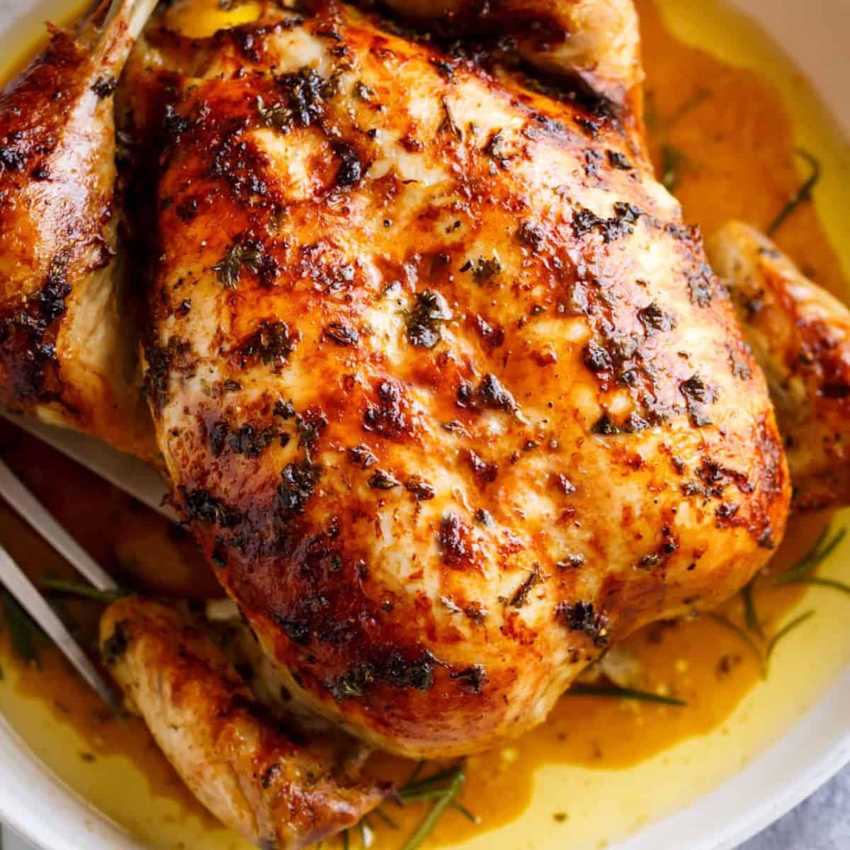 Roast chicken with herb butter, offering an appetizing look. 