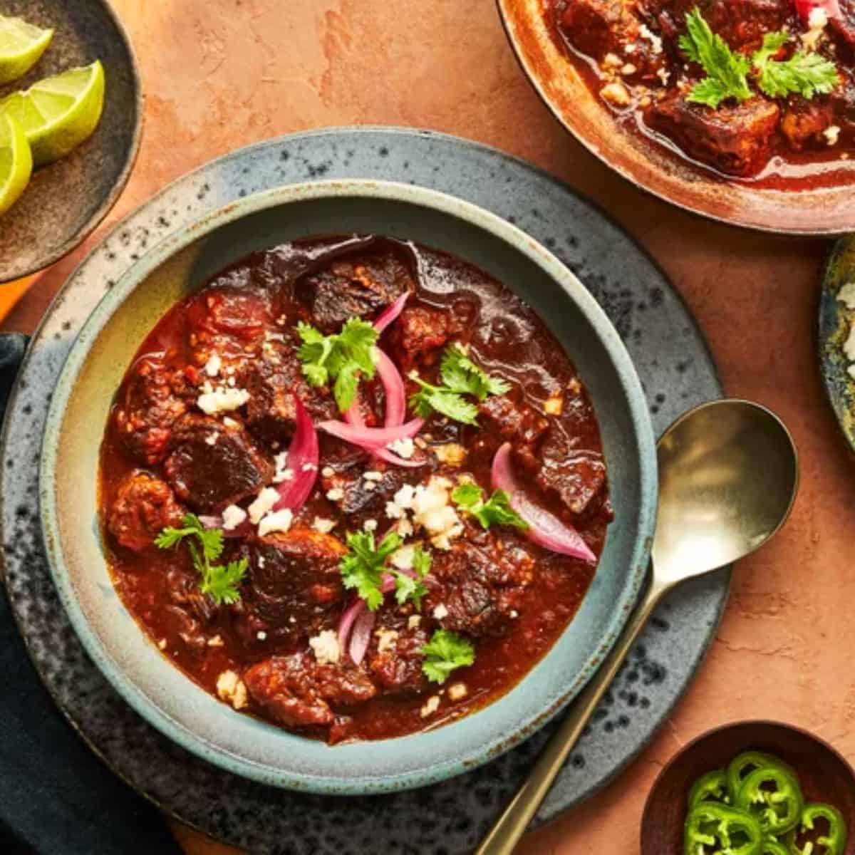A hearty bowl of Short Rib Chili, featuring tender short ribs, beans, tomatoes, and a rich blend of spices for a comforting, flavorful dish.
