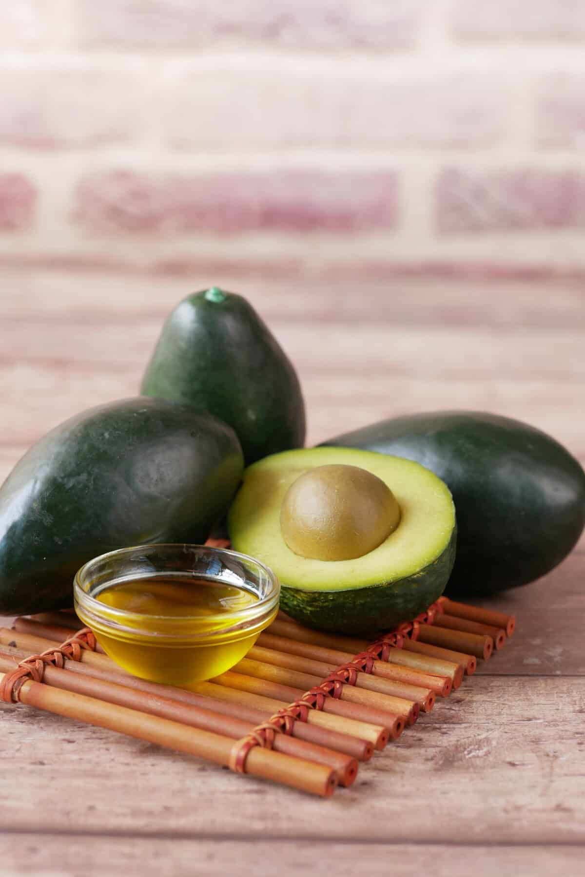 avocado and avocado oil on wooden table