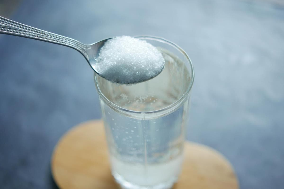white sugar in a glass of water