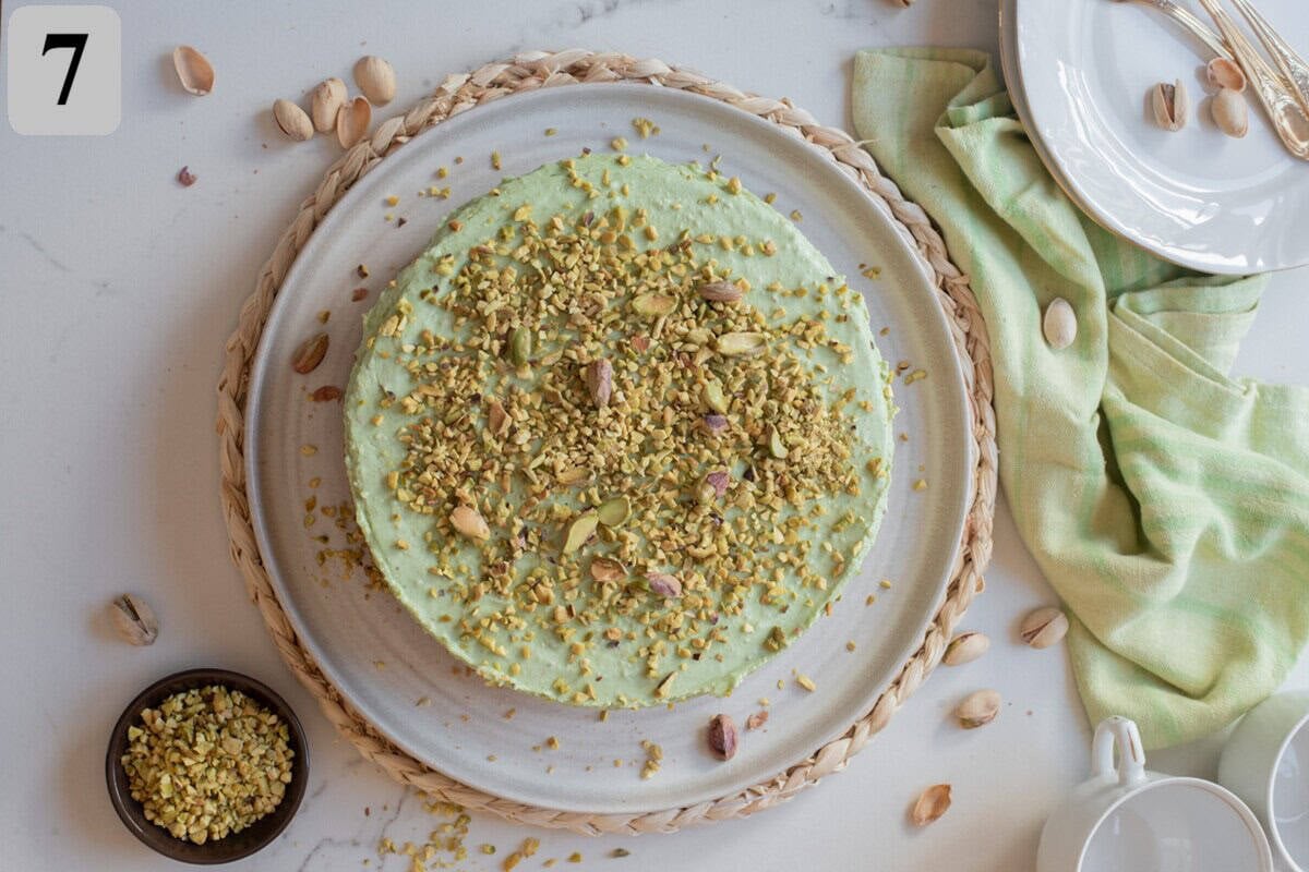 Top with chopped pistachios and whipped cream before slicing and serving.