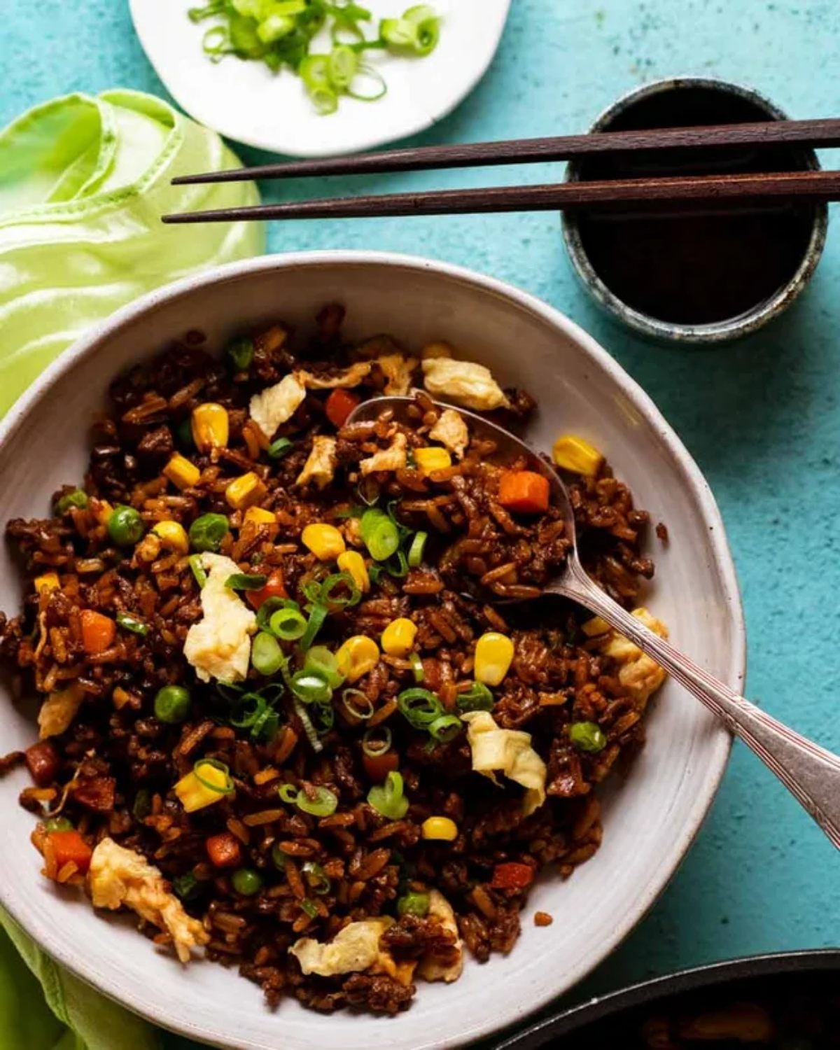 Easy ground beef fried rice with corn, peas, and eggs in a bowl for a quick 25 minute dinner recipe