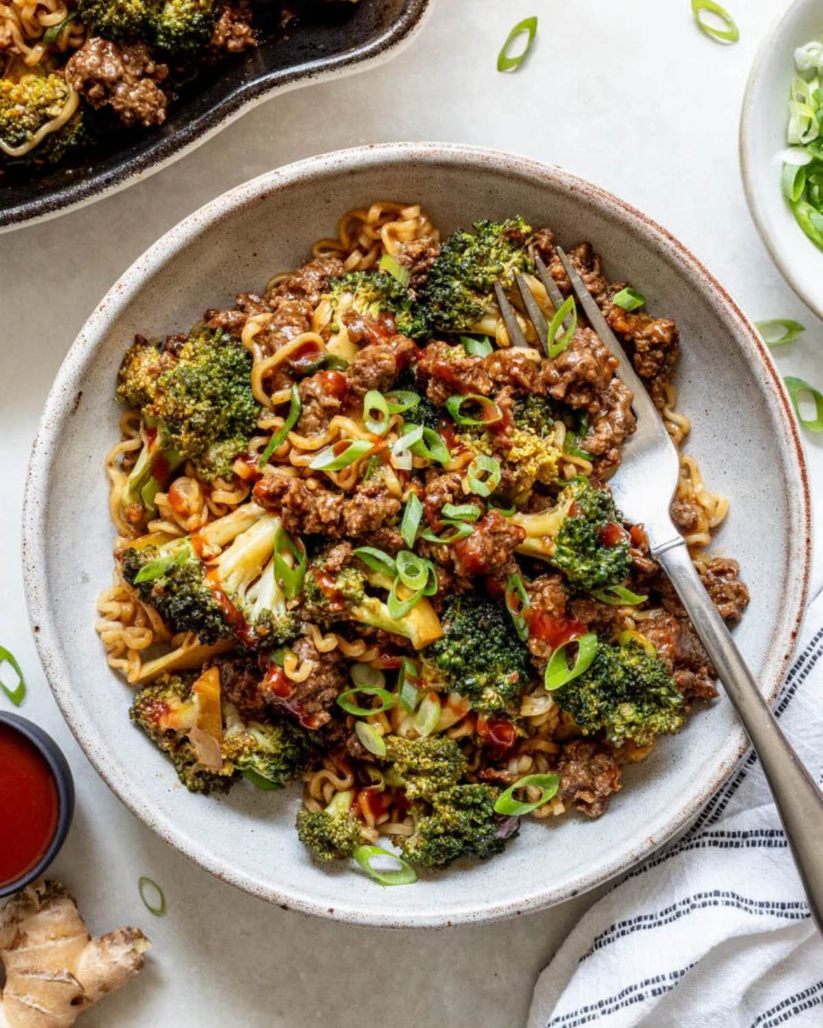 Ground beef and broccoli noodles in a bowl with a fork, representing an easy dinner recipe