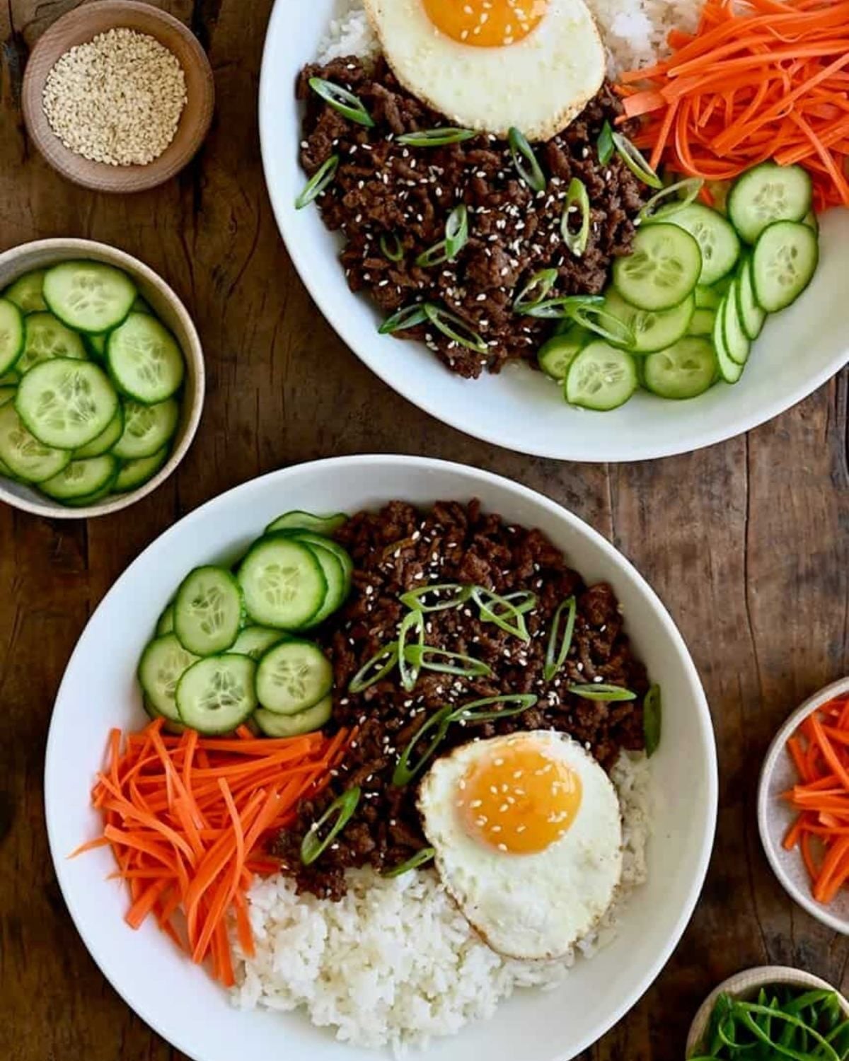 Korean ground beef bowls served with rice, fried egg, cucumbers, and carrots for an easy dinner recipe